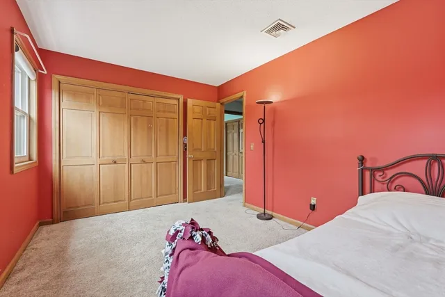 a bedroom with a bed and a closet