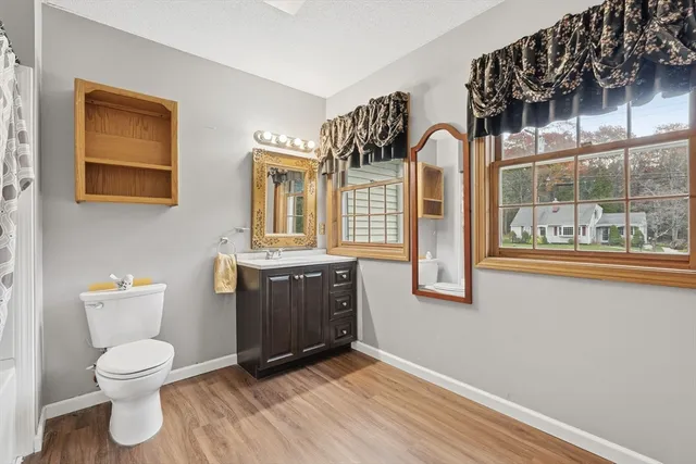 a bathroom with a toilet sink and mirror