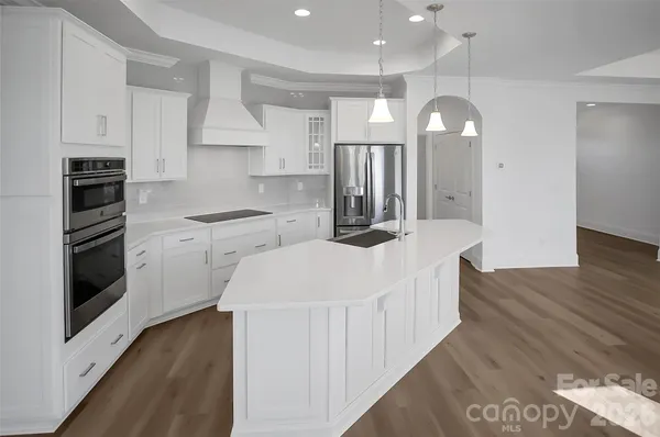 a kitchen with a sink stove and cabinets