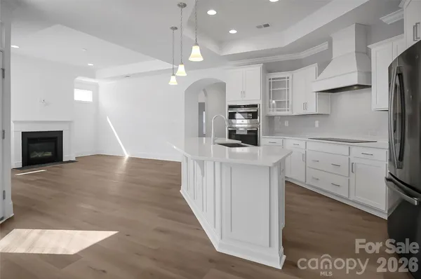 a kitchen with stainless steel appliances a stove refrigerator sink and microwave