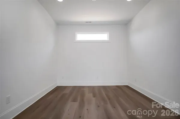 a view of an empty room and wooden floor