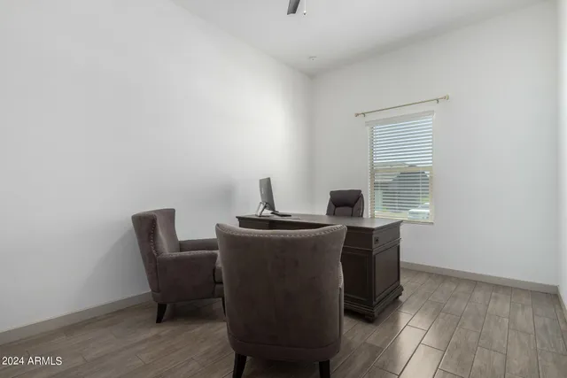 a dining room with table chairs and wooden floor