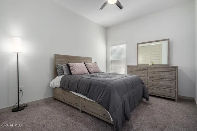 a bedroom with a bed and a night stand