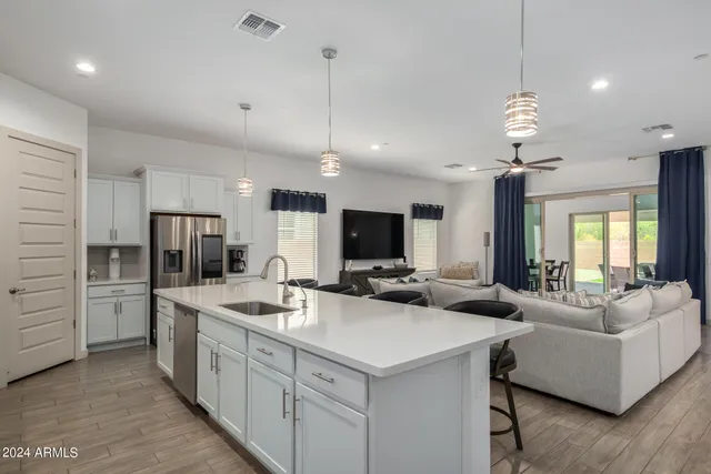 a large kitchen with kitchen island a sink appliances and a couch