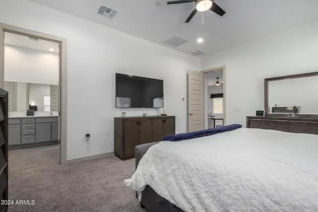 a bedroom with a bed and a flat screen tv