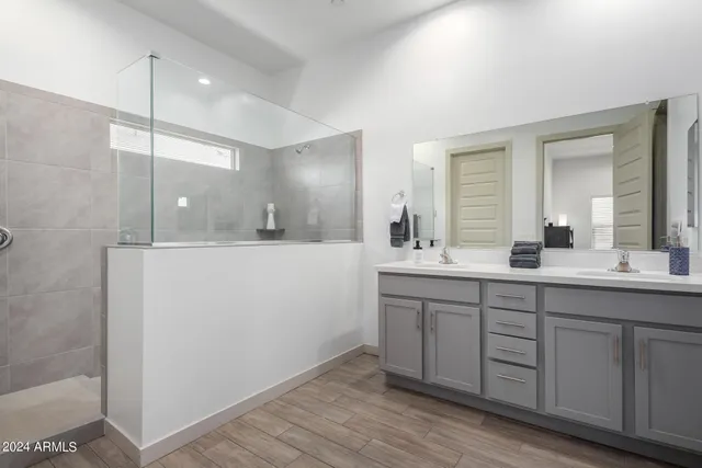 a bathroom with a double vanity sink and mirror