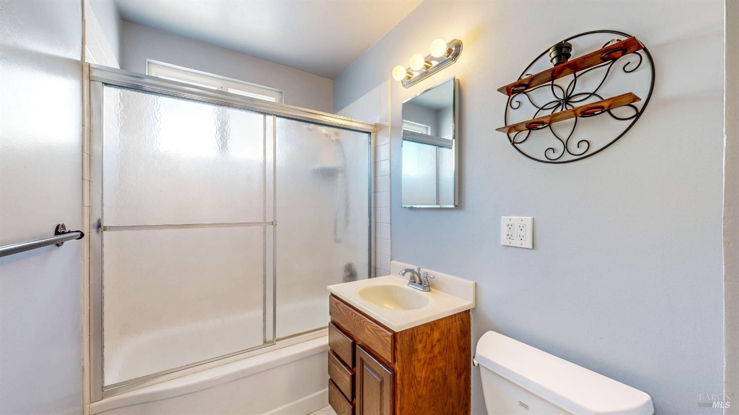 809 Maple Avenue Vallejo, CA 94591 - Photo 18 of 46 a bathroom with a mirror a sink and a shower