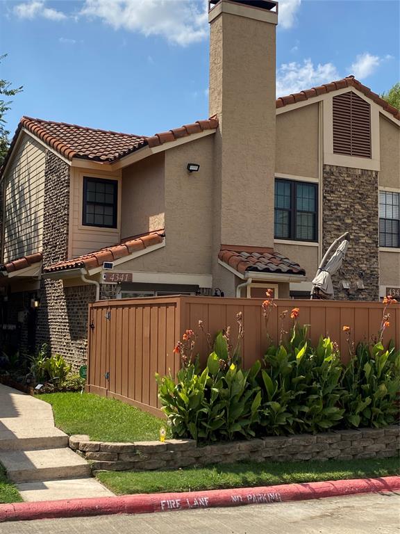 a front view of a house with plants
