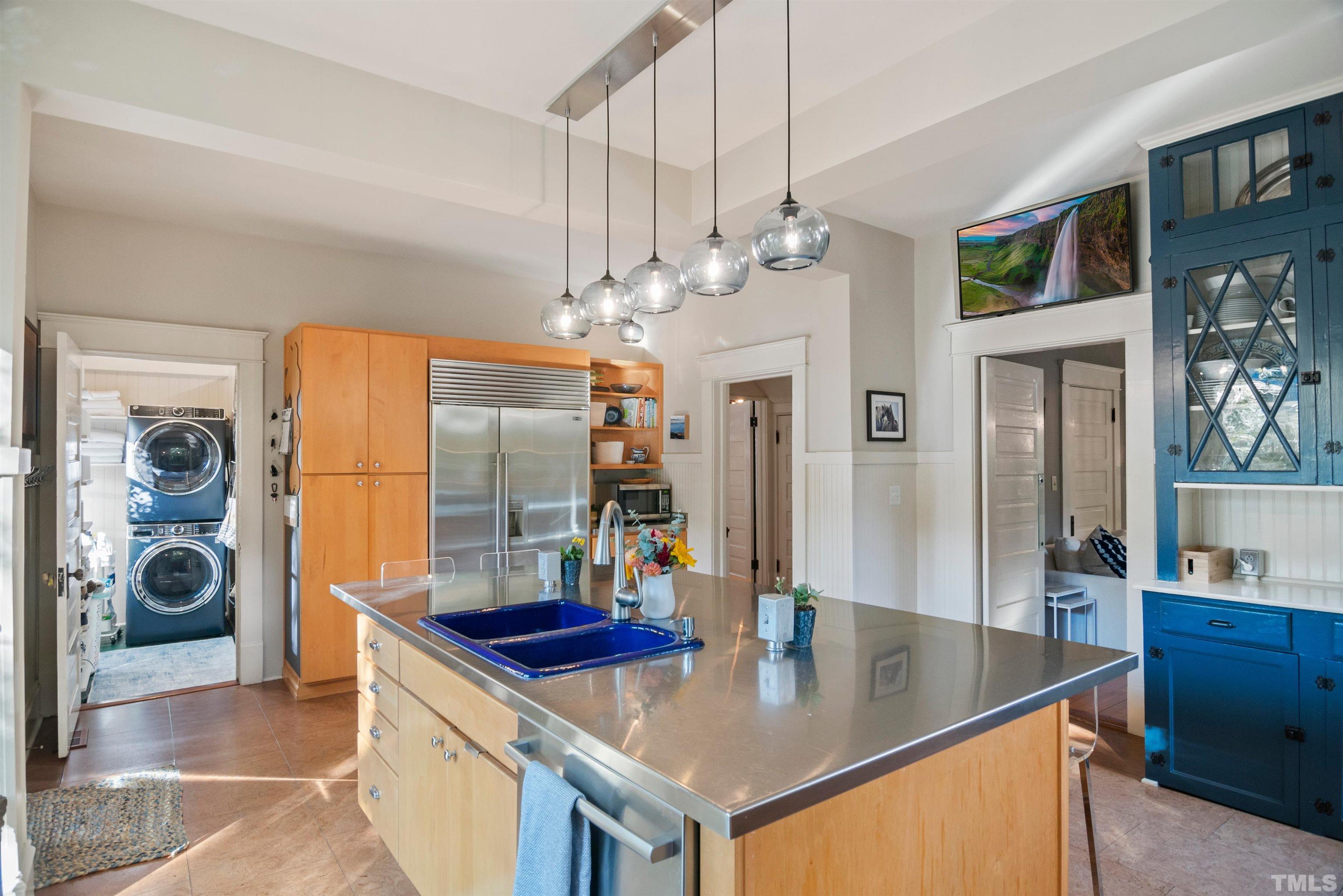 115 Watts Street Durham, NC 27701 - Photo 12 of 30 a kitchen with stainless steel appliances granite countertop a sink a stove and a refrigerator