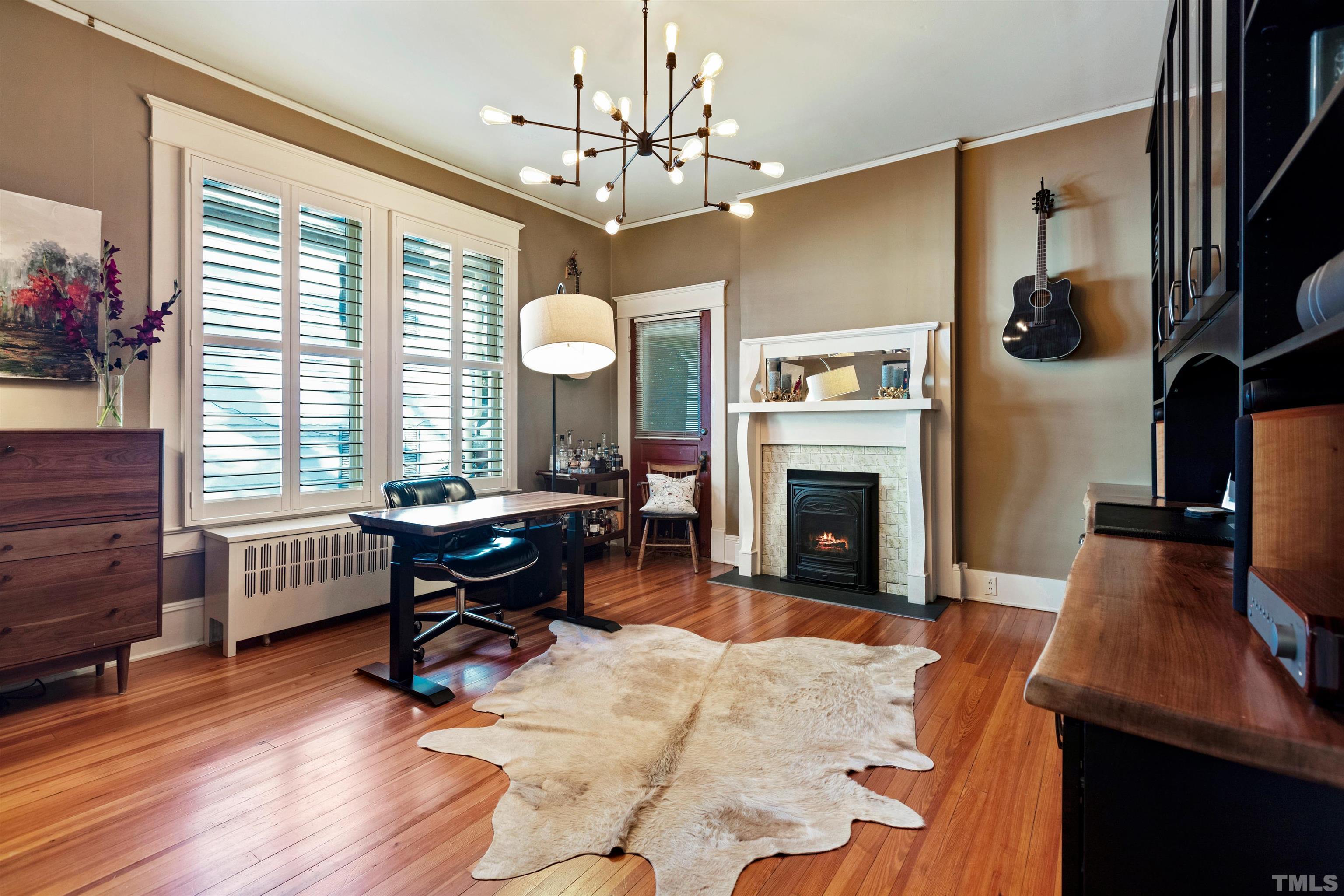 115 Watts Street Durham, NC 27701 - Photo 13 of 30 a living room with furniture a fireplace and a flat screen tv