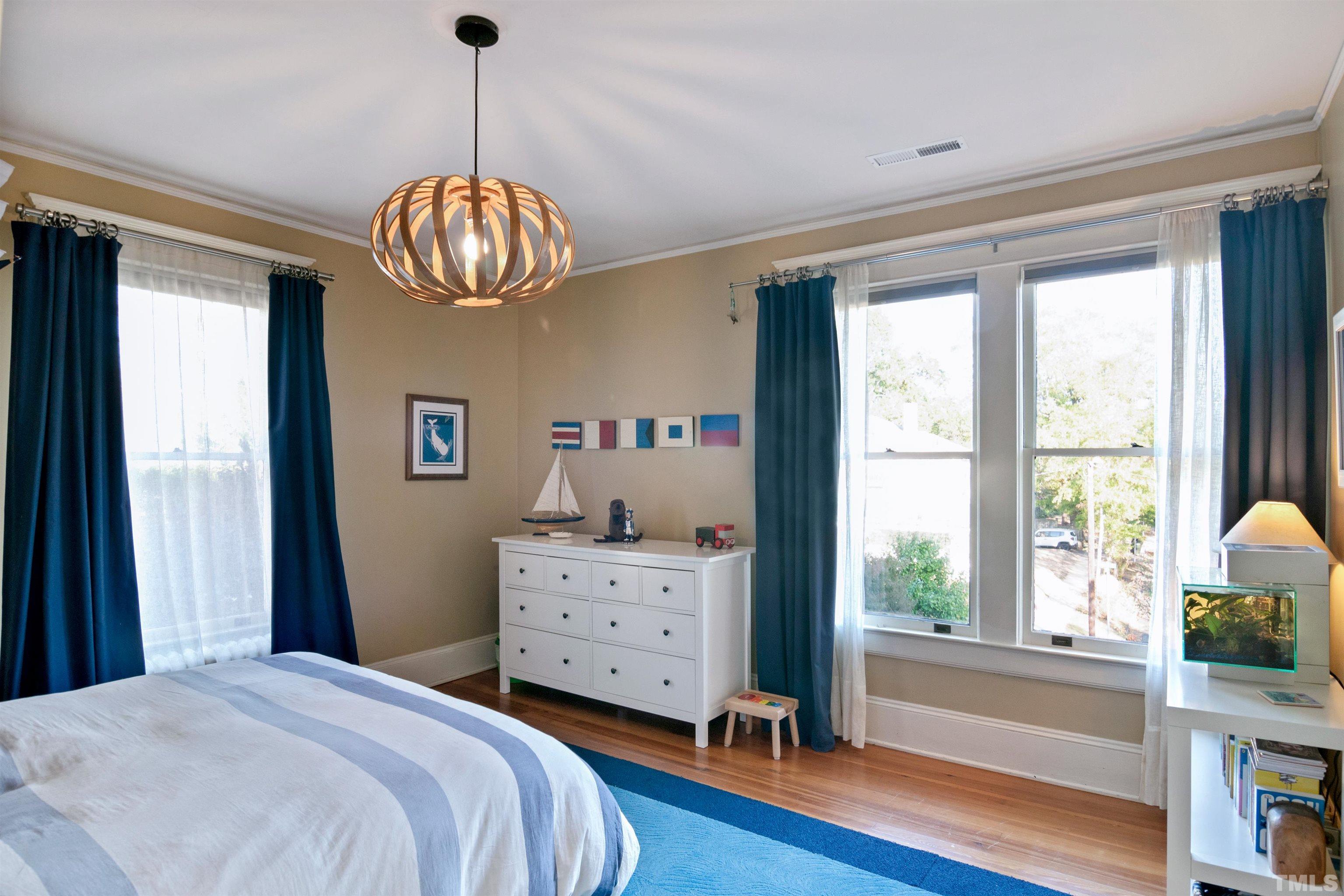 115 Watts Street Durham, NC 27701 - Photo 19 of 30 a bedroom with a bed and a chandelier