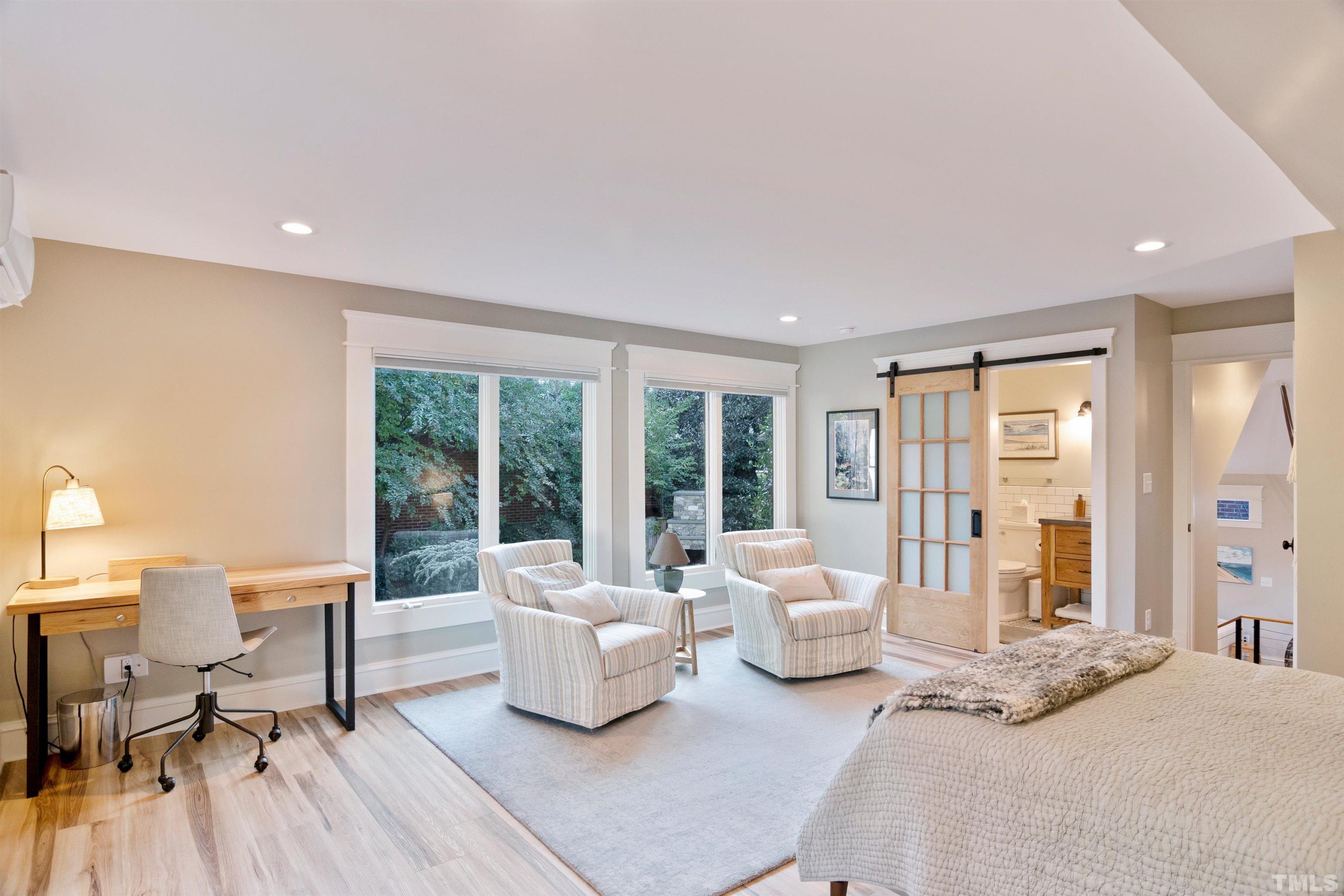 115 Watts Street Durham, NC 27701 - Photo 28 of 30 a spacious bedroom with a bed and large windows
