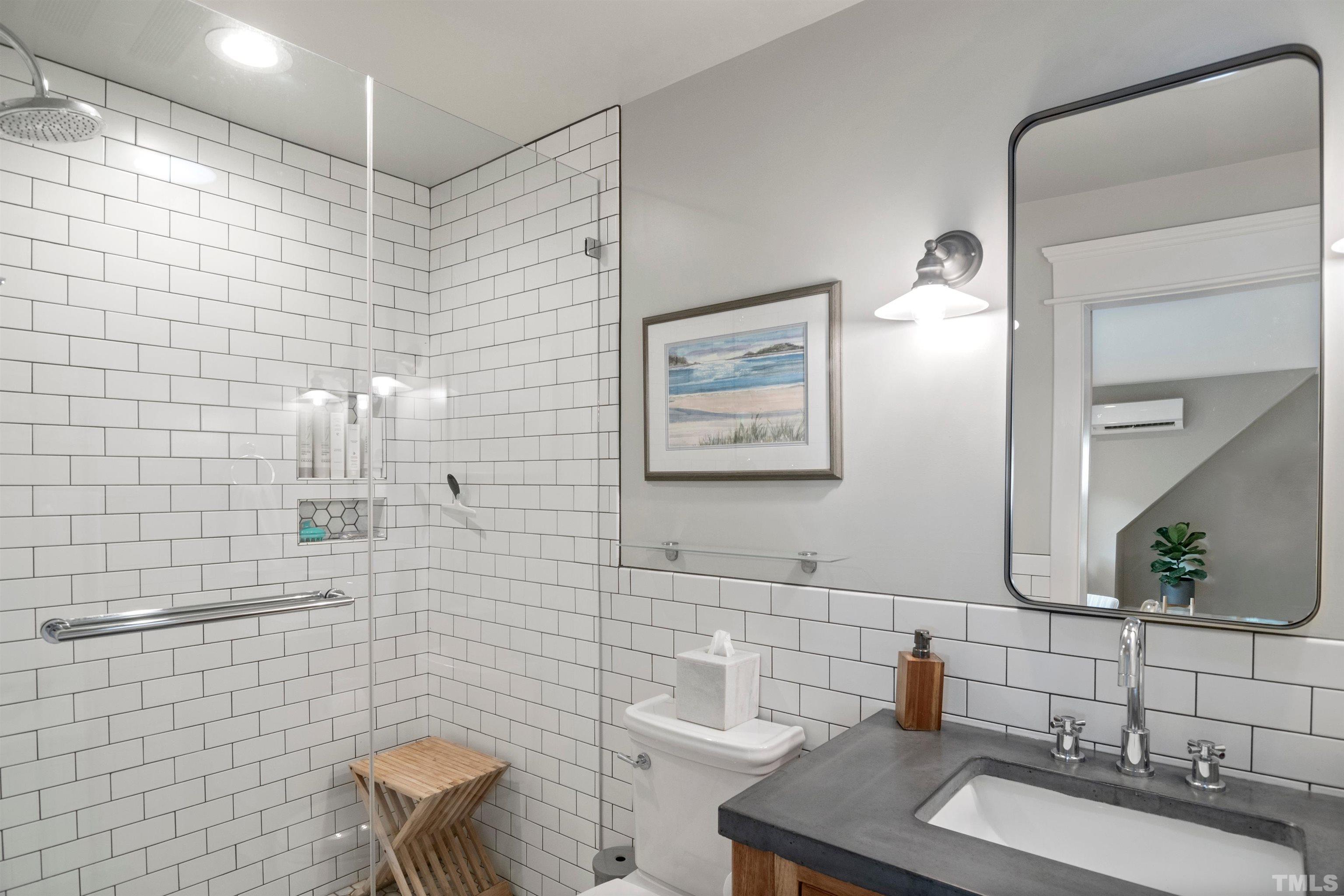 115 Watts Street Durham, NC 27701 - Photo 29 of 30 a bathroom with a sink a toilet and mirror
