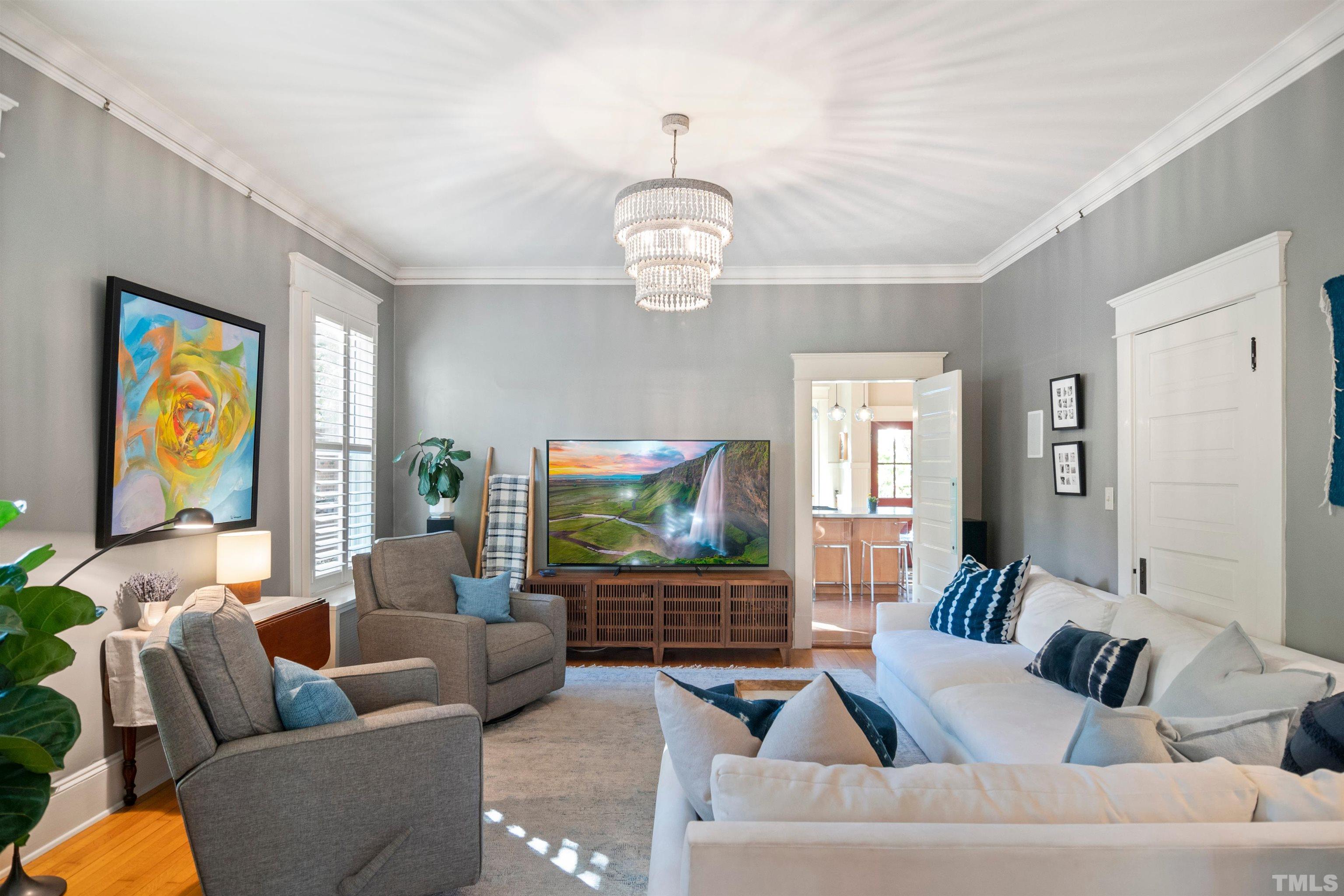 115 Watts Street Durham, NC 27701 - Photo 7 of 30 a living room with fireplace furniture and a flat screen tv