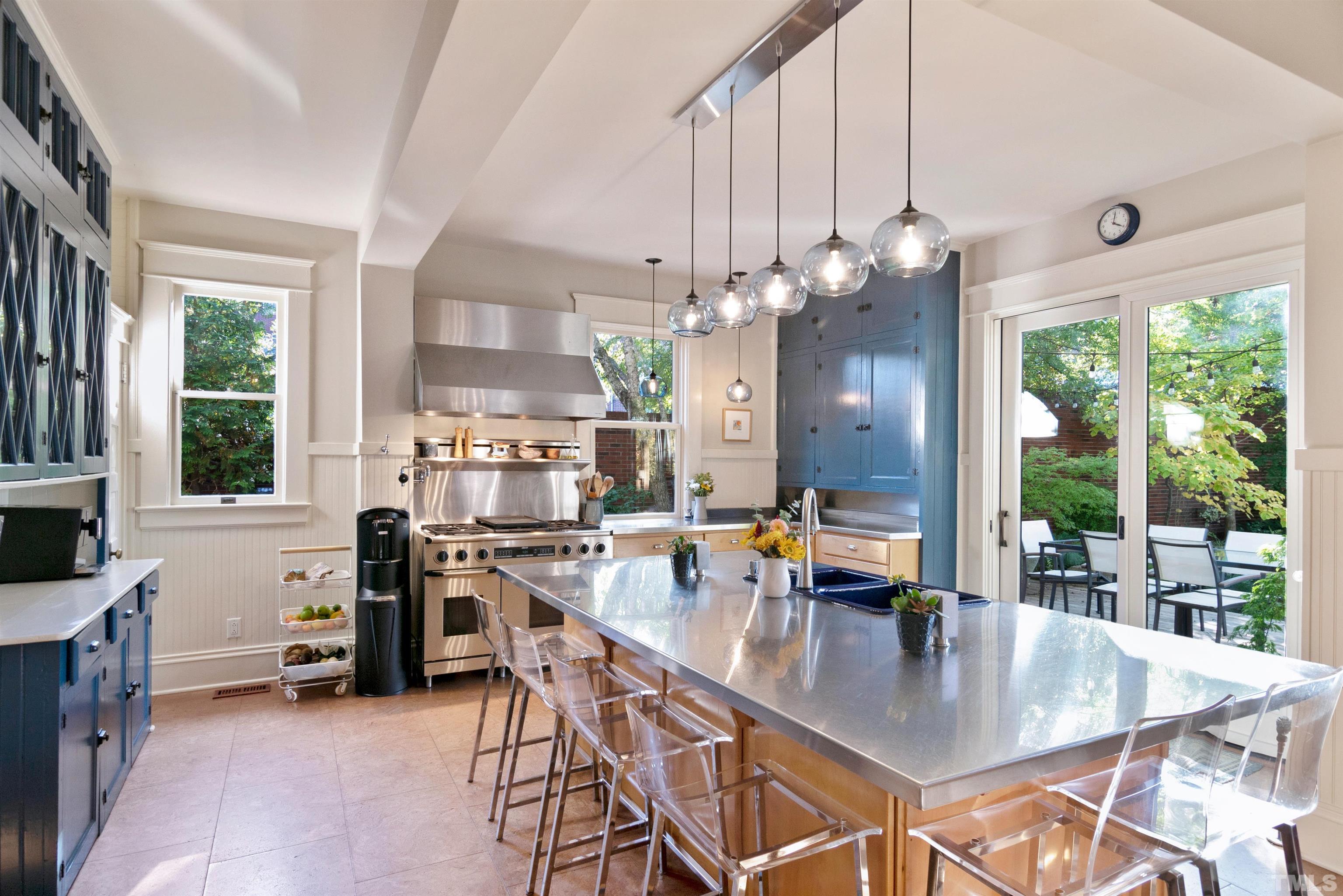 115 Watts Street Durham, NC 27701 - Photo 10 of 30 a very nice looking dining room with a large dining table and a large window with garden view