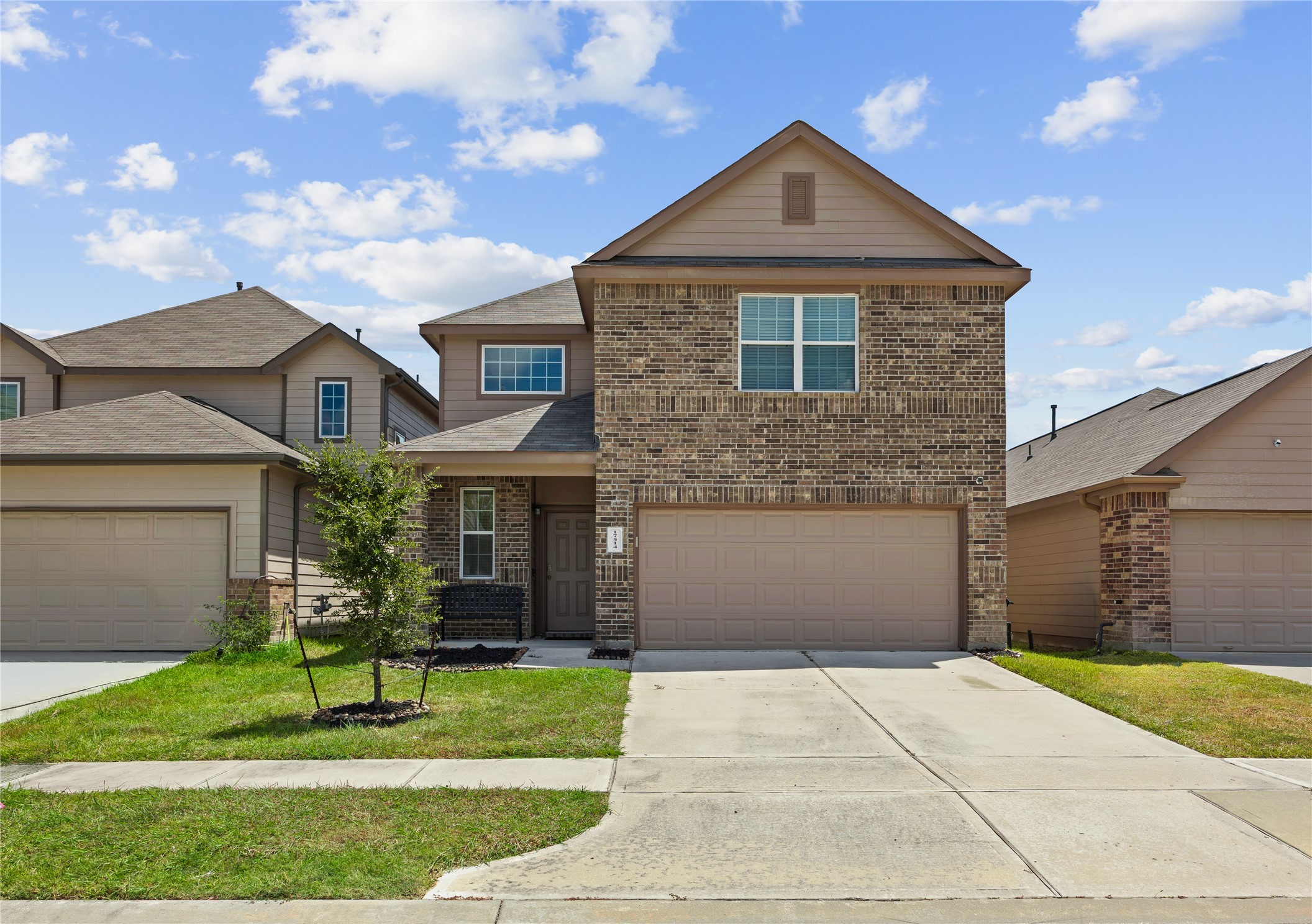 17514 Cuthbert Street Humble, TX 77346 - Photo 1 of 19 Charming two-story home showcases a classic brick facade, a spacious two-car garage, and a neatly manicured front lawn, perfect for modern family living.