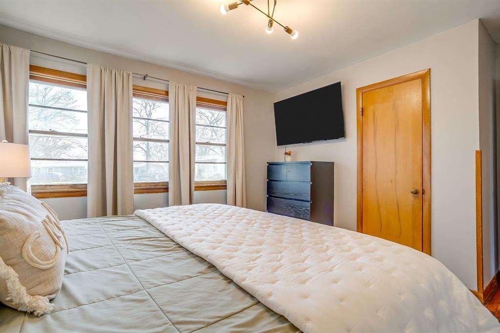 809 Euclid Street Cleburne, TX 76033 - Photo 15 of 26 a bedroom with a bed and a flat screen tv