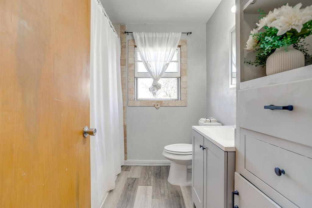 809 Euclid Street Cleburne, TX 76033 - Photo 19 of 26 a bathroom with a sink toilet and shower