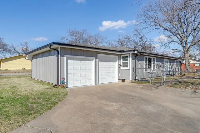 a view of a house with a yard and garage