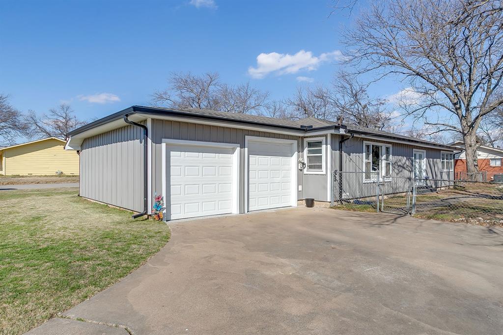 809 Euclid Street Cleburne, TX 76033 - Photo 2 of 26 a view of a house with a yard and garage