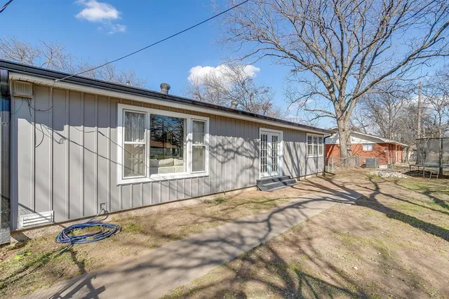 a view of a house with a patio and a yard