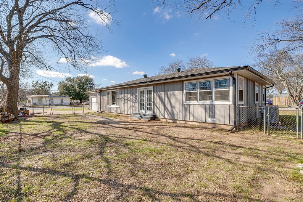 809 Euclid Street Cleburne, TX 76033 - Photo 23 of 26 a view of a house with a patio and a yard