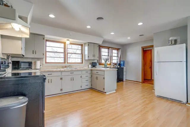 a kitchen with a refrigerator and a stove top oven