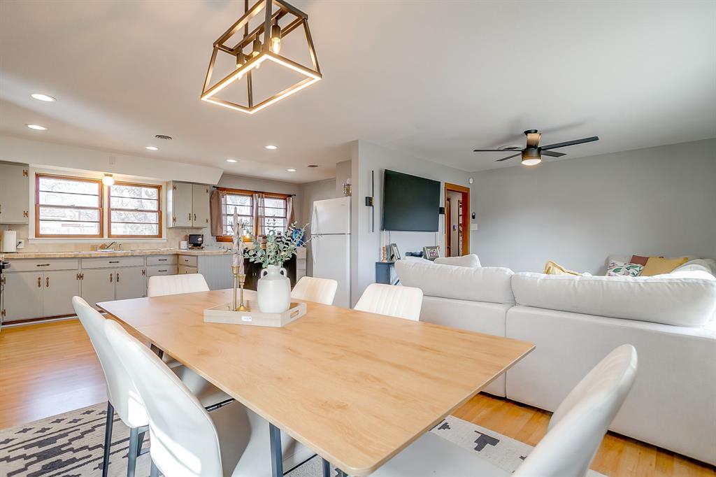 809 Euclid Street Cleburne, TX 76033 - Photo 9 of 26 a living room with furniture and a dining table with projector