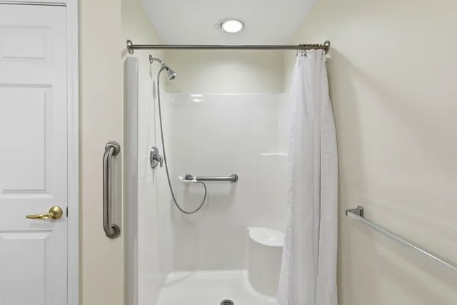 a bathroom with a shower and a shower