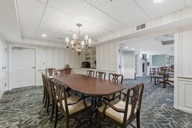 a view of a dining room with furniture and chandelier