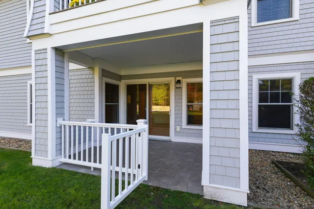 a view of a house with backyard and porch