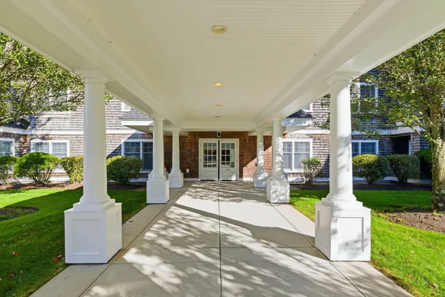 a front view of a house with garden and patio