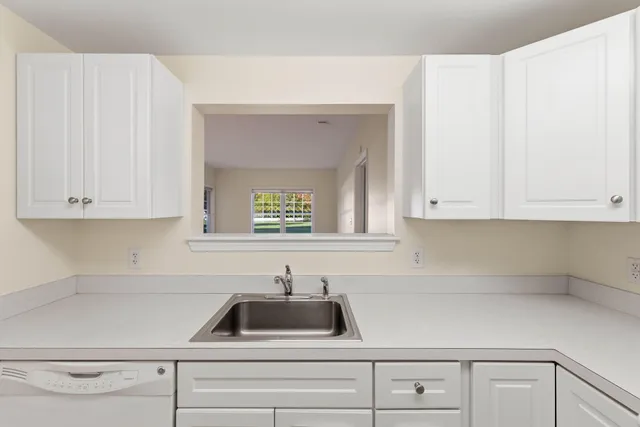 a kitchen with white cabinets and a sink