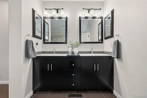 a bathroom with double sink and a mirror