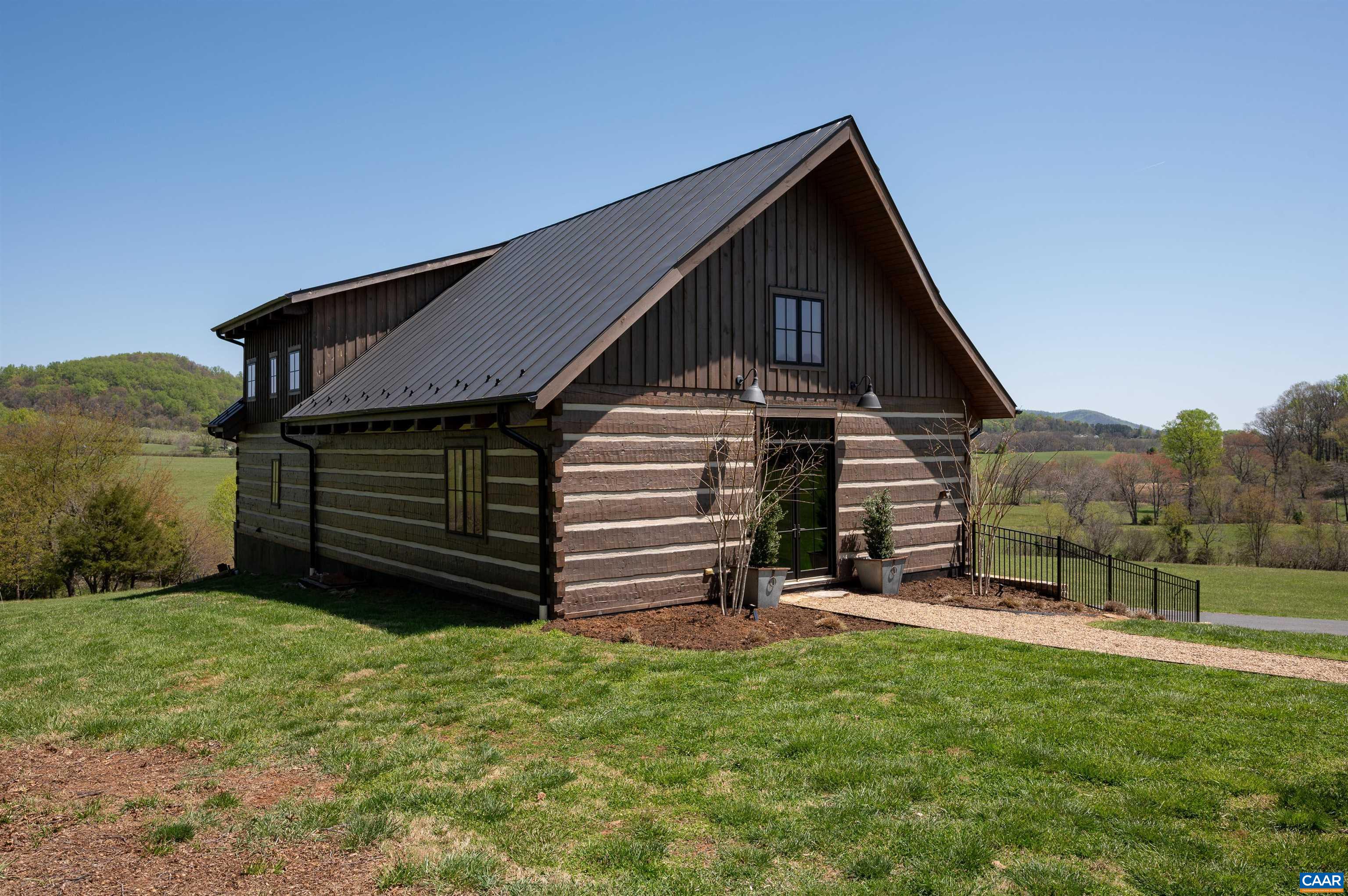 3140 Sutherland Road North Garden, VA 22959 - Photo 23 of 37 a view of a house with a small yard and wooden fence