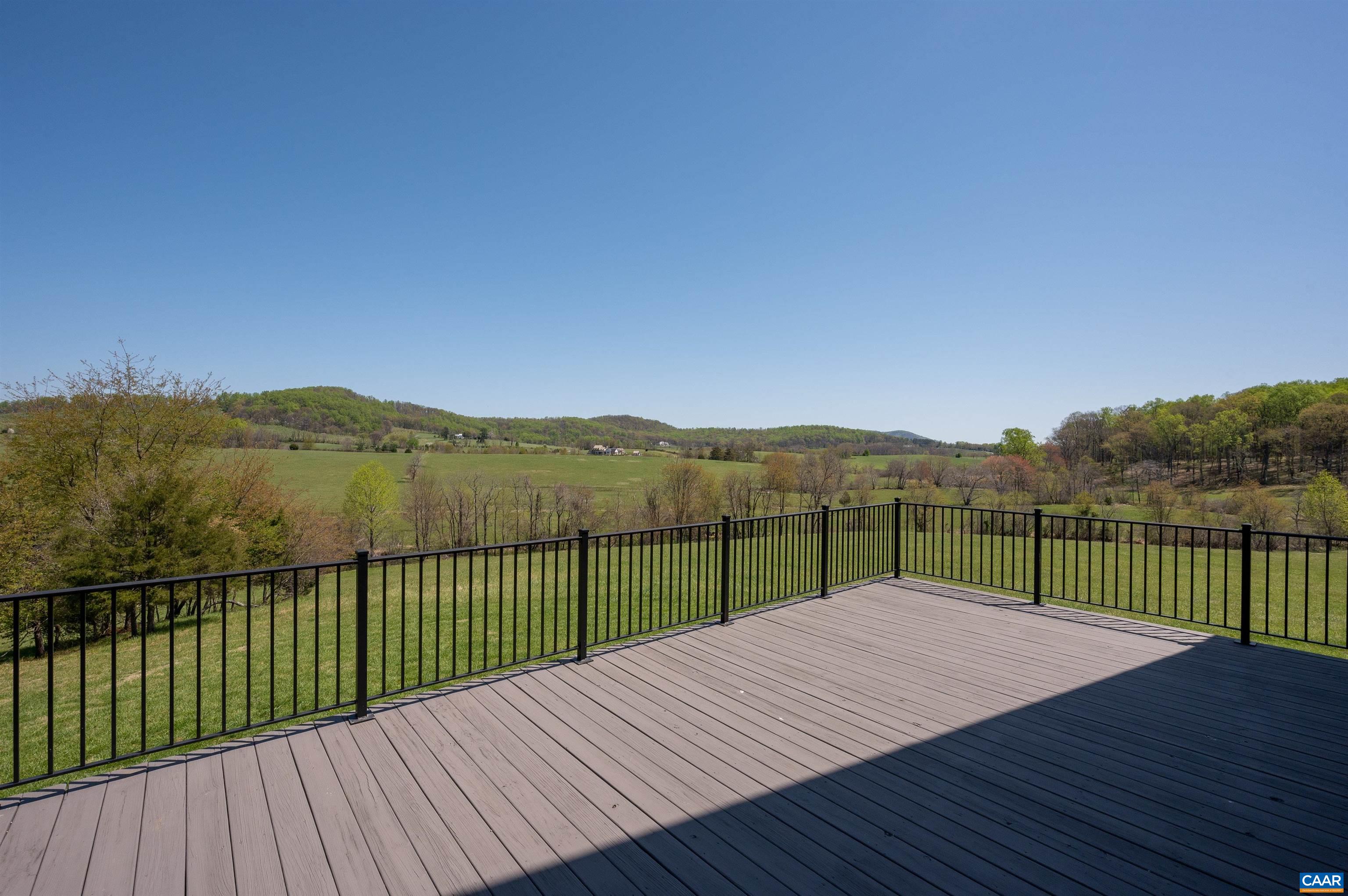 3140 Sutherland Road North Garden, VA 22959 - Photo 27 of 37 a view of a wooden deck with a lake view