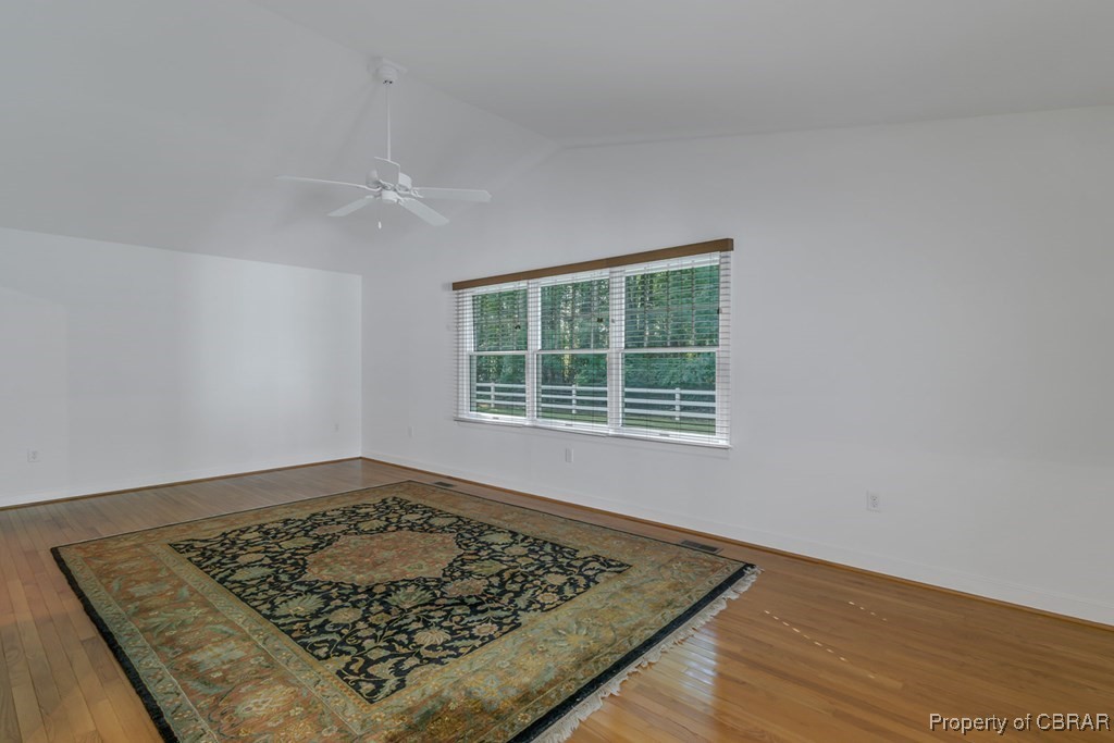 35 Powhatan Road Kilmarnock, VA 22482 - Photo 17 of 42 Spare room with wood finished floors, baseboards, lofted ceiling, and ceiling fan