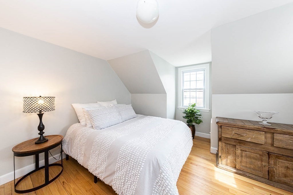26 Bow Road Newton, MA 02459 - Photo 28 of 37 a bedroom with a bed and a potted plant on the dresser