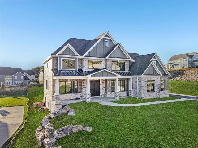 a front view of a house with a garden and plants