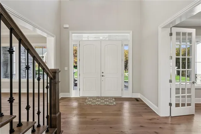 a living room with furniture a rug and a large window