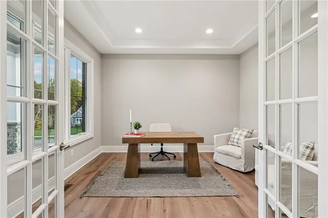a view of entryway and hall with wooden floor