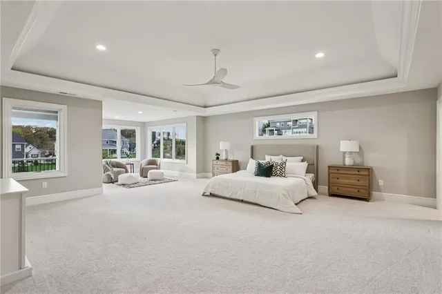 a bedroom with a large bed and a chandelier