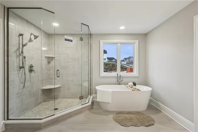 a spacious bathroom with a double vanity sink a large mirror and a shower