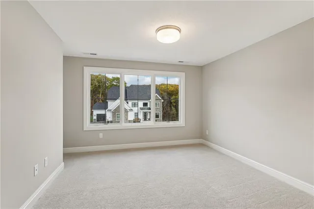 a bathroom with a granite countertop sink toilet a large mirror a bathtub and shower