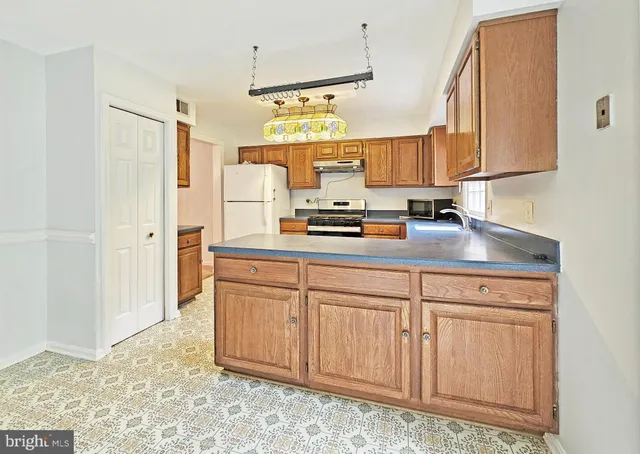 a kitchen with cabinets appliances and a sink