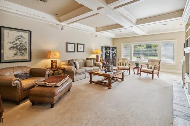 a kitchen with granite countertop a stove a sink a dining table and chairs