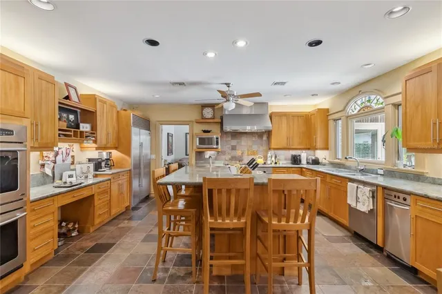 a dining area with stainless steel appliances a dining table and chairs