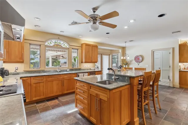 a bathroom with a granite countertop sink a toilet and shower