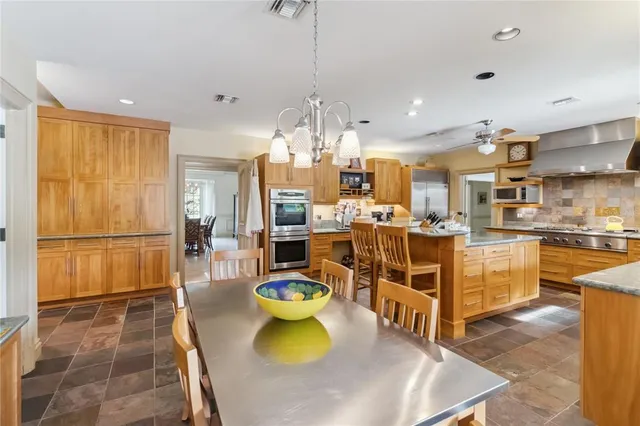a bathroom with a granite countertop double vanity sink and a mirror