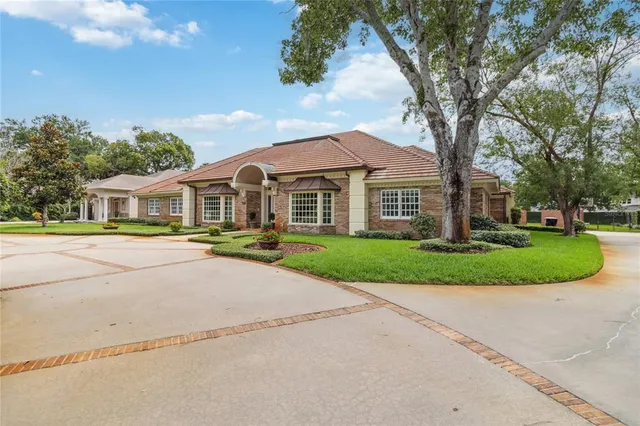 a front view of a house with a yard and trees